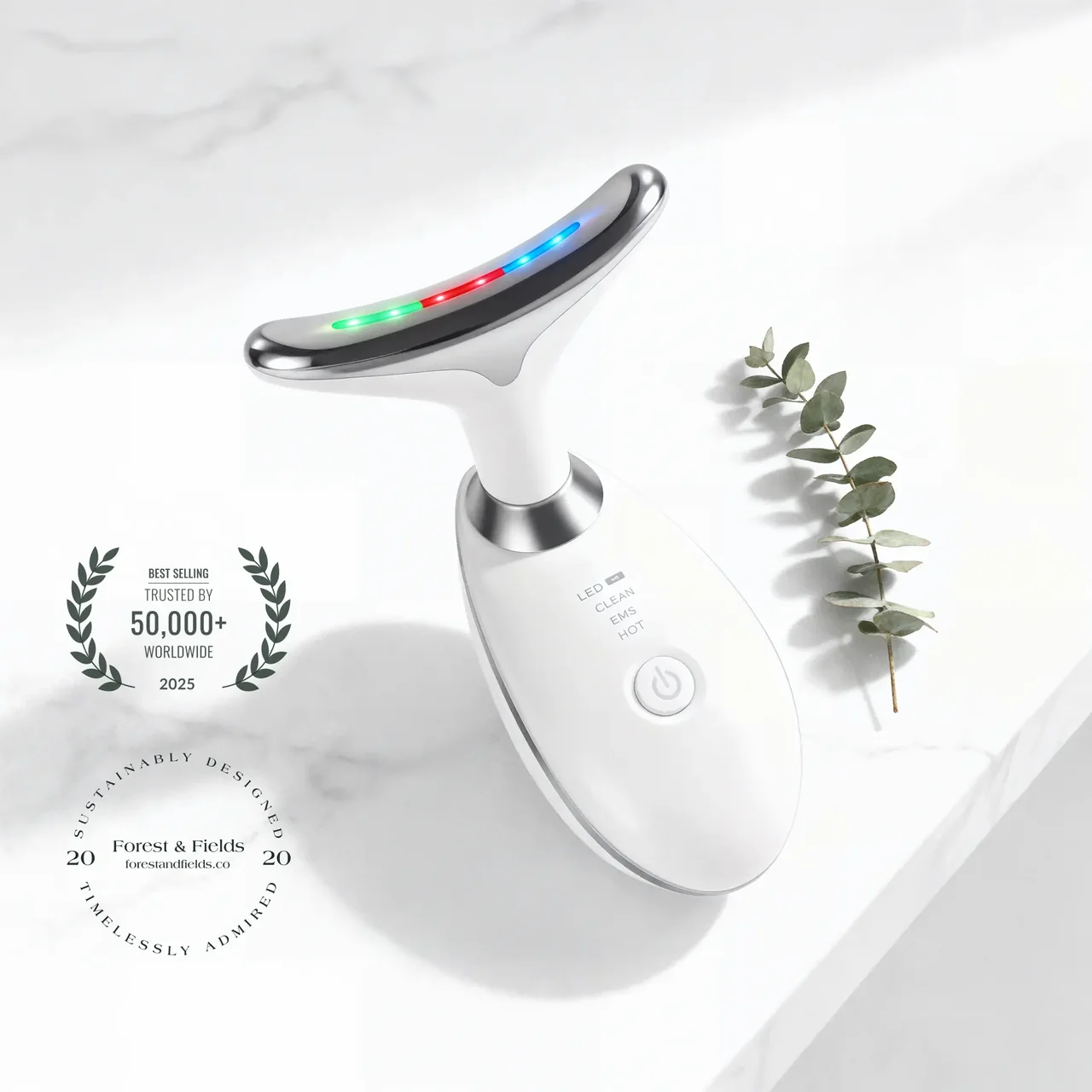 NordicGlow™ LED face massager on marble with eucalyptus